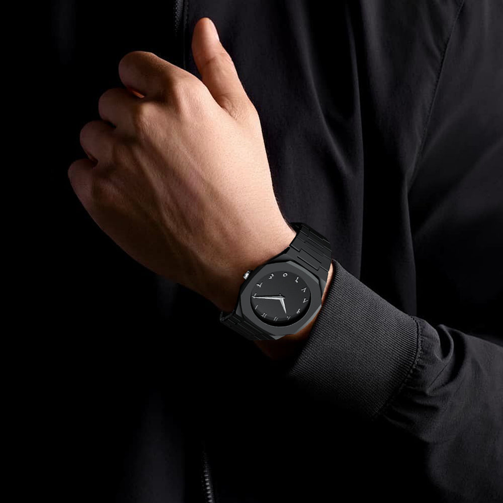 Person wearing a black smartwatch on a dark background