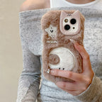 Person holding a fluffy phone case with a cat design