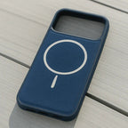 Blue phone case with a white circular design on a wooden surface