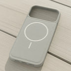 Gray phone case with a circular design on a wooden surface
