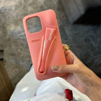 Person holding a pink phone case with 'nade' branding against a blurred background