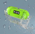 Green digital device with water droplets and splashes on a gray background