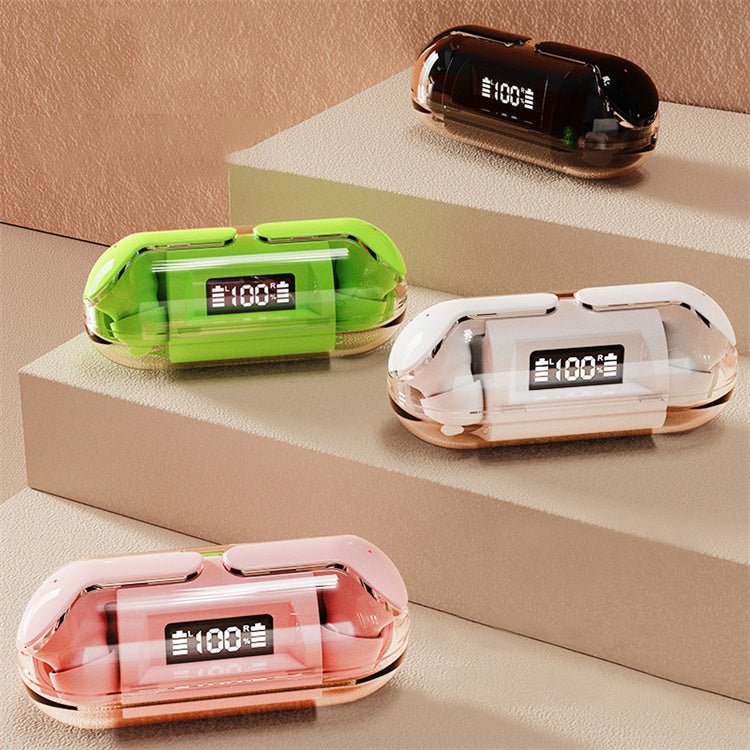 Four colorful electronic devices with digital displays on a beige surface.