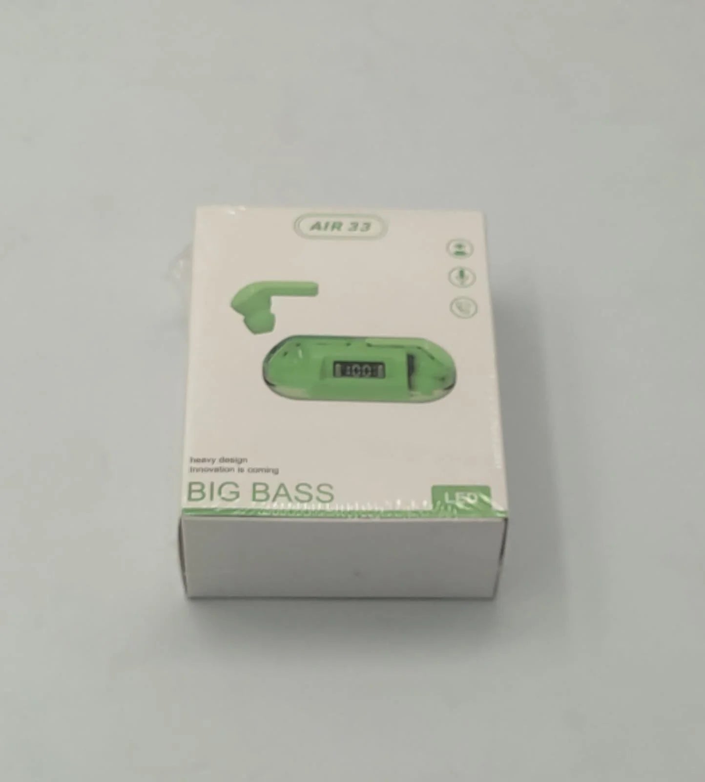Green electronic device packaging with 'BIG BASS' text on a white background