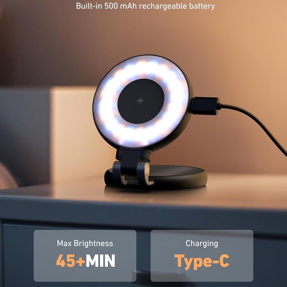 Ring light with charging cable on a surface, featuring text about battery life and charging type.