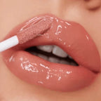 Close-up of a person applying lip gloss with a brush